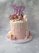 Pink buttercream drip cake with strawberries 21st birthday